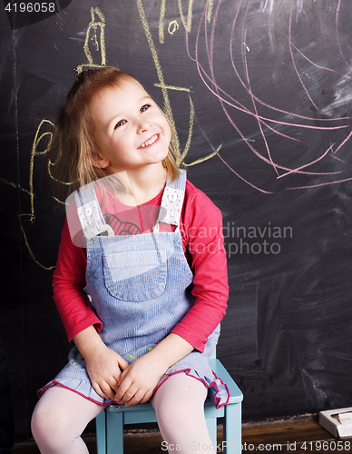 Image of liittle cute girl in classroom near blackboard, lifestyle people concept