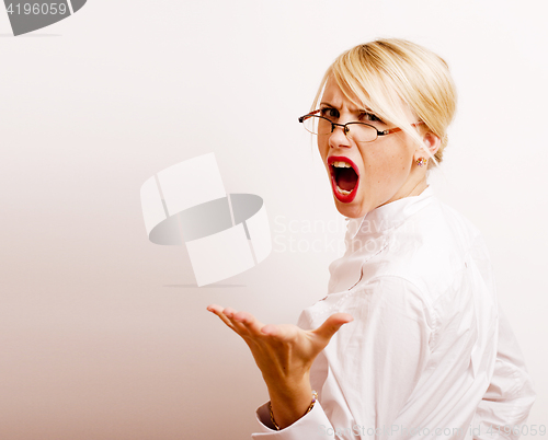 Image of very emotional businesswoman in glasses, blond hair on white background. teacher hands up posing isolated. pointing gesturing, lifestyle people concept 