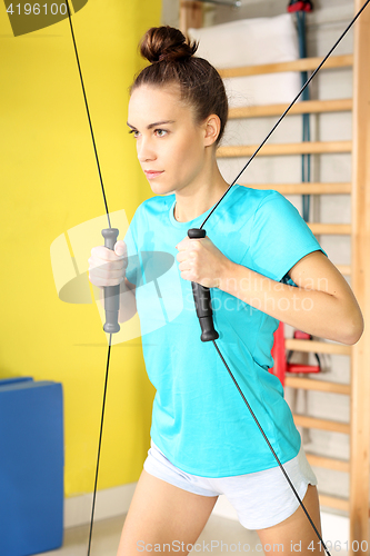 Image of Workout at the gym. Rehabilitation, training with rubbers.