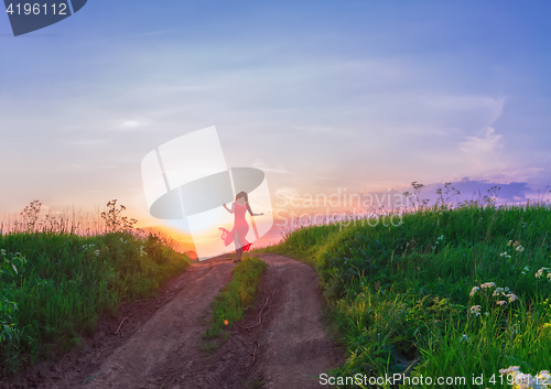 Image of Young Woman Dancing Against The Sunset