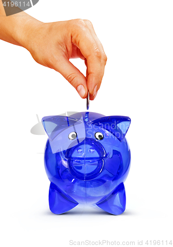 Image of isolated hand putting coin into piggy bank