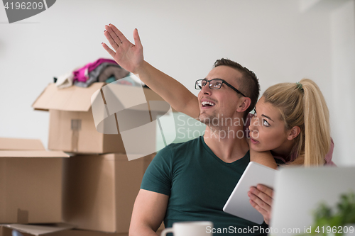 Image of Young couple moving in a new home