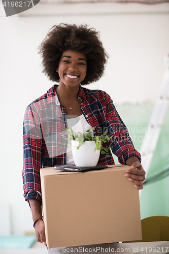 Image of Black girl moving in the new apartment