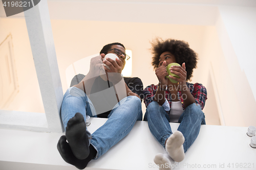 Image of couple having break during moving to new house