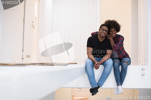 Image of couple having break during moving to new house