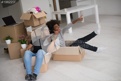 Image of African American couple  playing with packing material