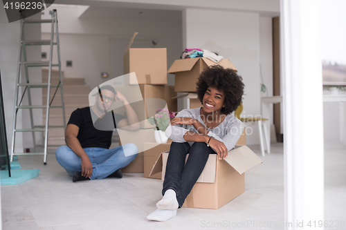 Image of African American couple  playing with packing material