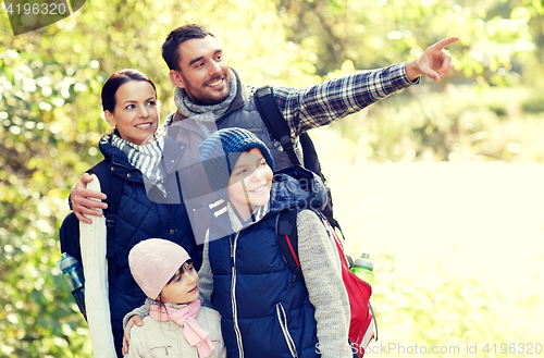 Image of happy family with backpacks hiking