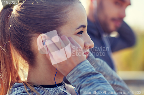 Image of happy woman with earphones listening to music
