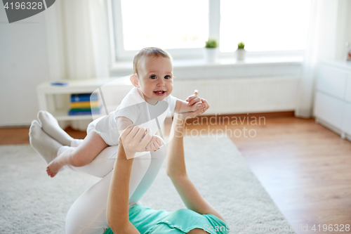 Image of happy mother playing with baby at home
