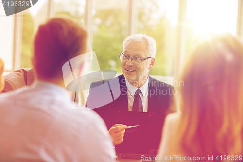 Image of business people with laptop meeting in office