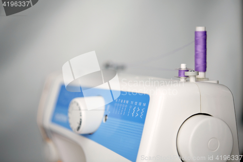 Image of thread spools on sewing machine