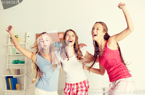 Image of happy friends or teen girls having fun at home