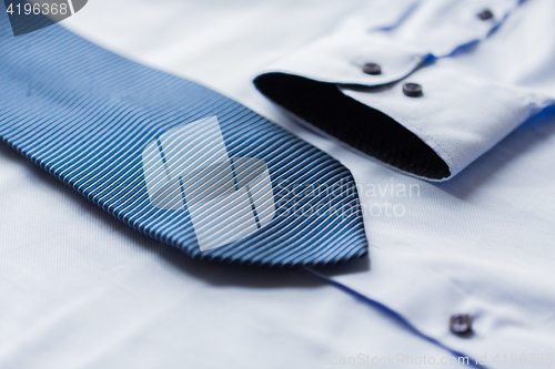 Image of close up of shirt and blue patterned tie