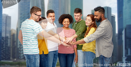 Image of international group of happy people holding hands