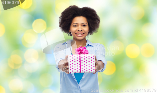 Image of happy african woman with birthday gift box