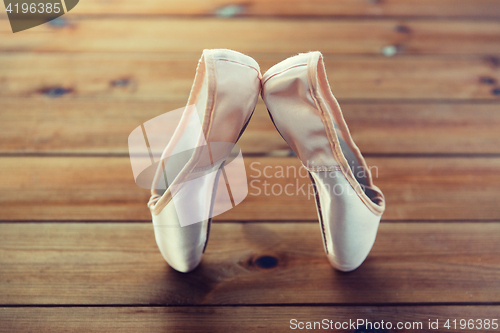 Image of close up of pointe shoes on wooden floor