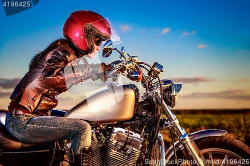 Image of Biker girl on a motorcycle