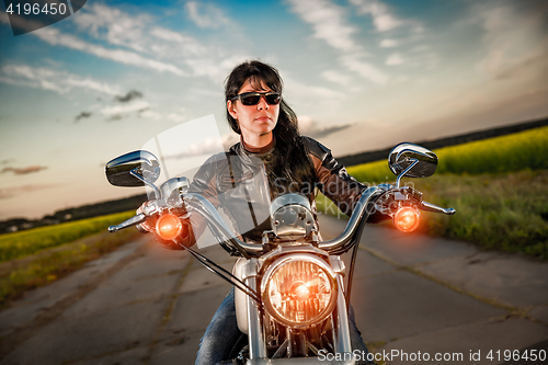 Image of Biker girl on a motorcycle