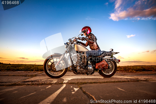 Image of Biker girl on a motorcycle