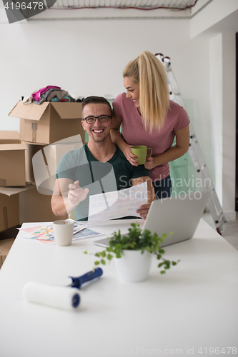 Image of Young couple moving in a new home