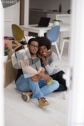 Image of African American couple relaxing in new house