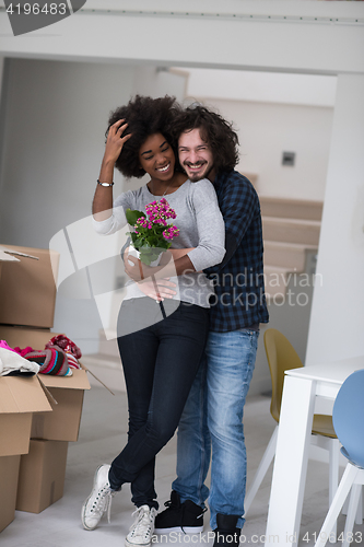 Image of multiethnic couple moving into a new home