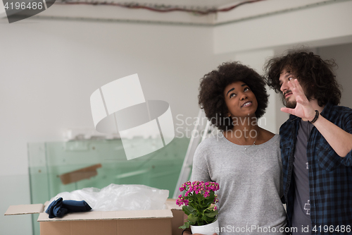 Image of multiethnic couple moving into a new home