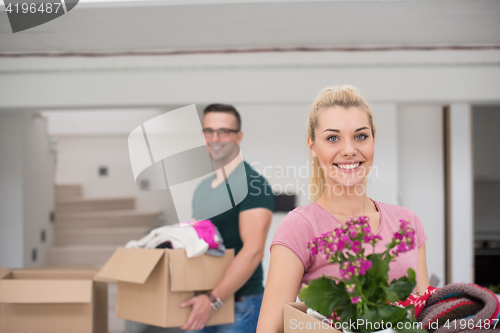 Image of young couple moving into a new home