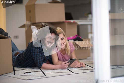 Image of Young couple moving in a new flat