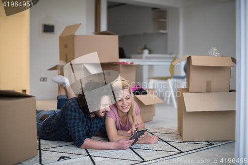 Image of Young couple moving in a new flat