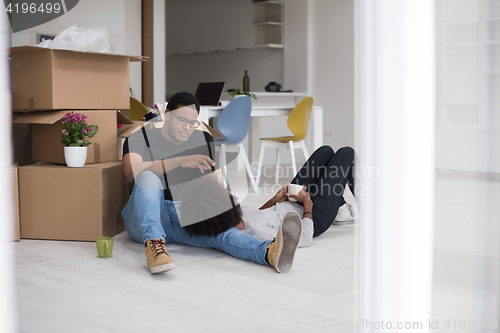 Image of African American couple relaxing in new house