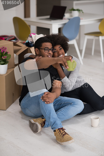 Image of African American couple relaxing in new house