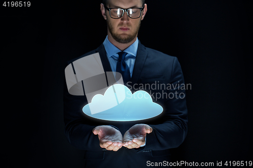 Image of businessman with cloud projection over black 