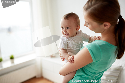 Image of happy young mother with little baby at home