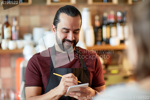 Image of man or waiter serving customer at bar