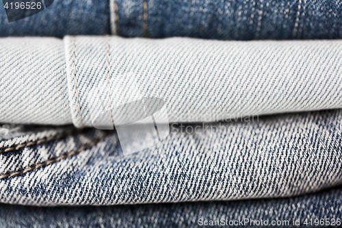 Image of close up of denim clothes or jeans pile