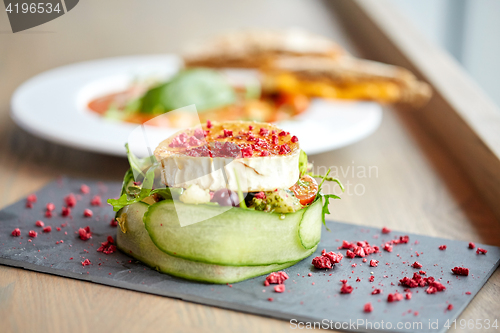 Image of goat cheese salad with vegetables at restaurant