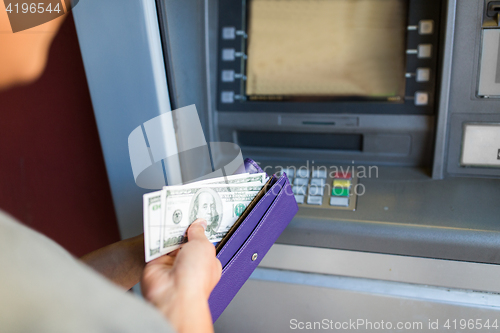 Image of close up of hand withdrawing money at atm machine