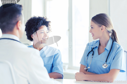 Image of group of happy doctors meeting at hospital office