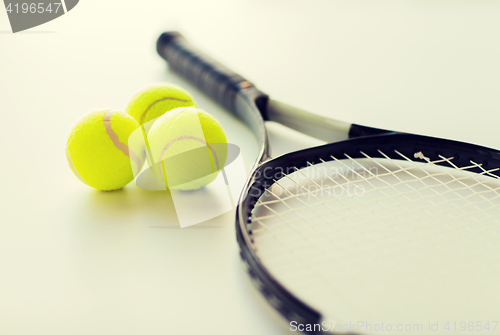 Image of close up of tennis racket with balls