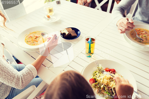 Image of close up of family having dinner at restaurant 