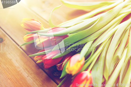 Image of close up of tulip flowers on wooden table