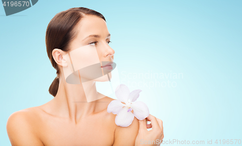 Image of beautiful young woman with orchid flower