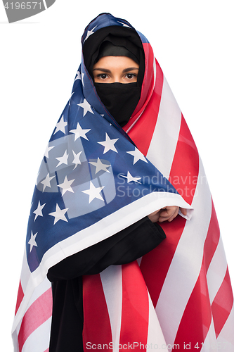 Image of muslim woman in hijab with american flag