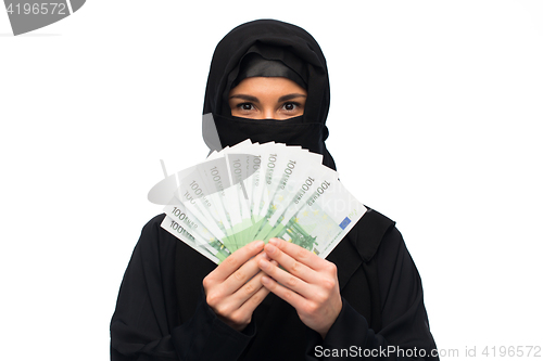 Image of muslim woman in hijab with money over white