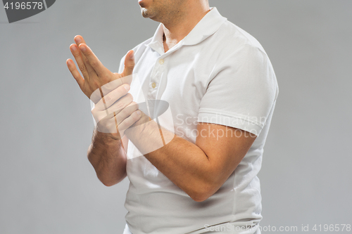 Image of close up of man suffering from pain in hand