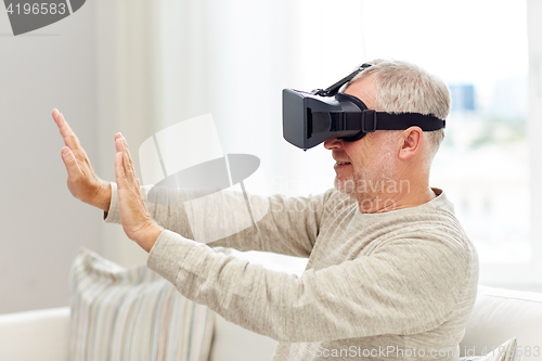 Image of old man in virtual reality headset or 3d glasses