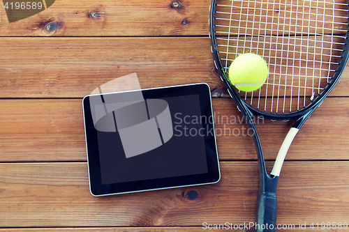 Image of close up of tennis racket with ball and tablet pc