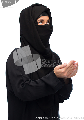 Image of praying muslim woman in hijab over white